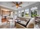 Bright sun room with a ceiling fan, comfortable seating, and large windows overlooking the backyard at 5981 Bison Ct, Fort Mill, SC 29707