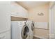 Laundry room with Samsung washer and dryer, cabinets, and wall art at 619 Samet St, Fort Mill, SC 29715