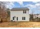 Two-story house with a fenced backyard, basketball hoop, and covered patio at 6204 Springbeauty Dr, Charlotte, NC 28227