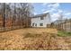Fenced backyard with a spacious lawn and two-story house at 6204 Springbeauty Dr, Charlotte, NC 28227