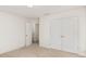 Cozy bedroom features neutral carpeting, a window, and a double-door closet at 6204 Springbeauty Dr, Charlotte, NC 28227