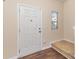 Inviting entryway features a white door, wood floors, and a window providing natural light at 6204 Springbeauty Dr, Charlotte, NC 28227