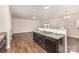 Kitchen sink and dishwasher in an open floorplan with granite countertops and hardwood floors at 6204 Springbeauty Dr, Charlotte, NC 28227