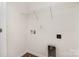 Bright laundry room with shelving, utility connections, and white walls at 6204 Springbeauty Dr, Charlotte, NC 28227