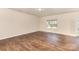 Bright living room with hardwood floors and a large window, open into the kitchen at 6204 Springbeauty Dr, Charlotte, NC 28227