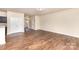 Open-concept living area with hardwood floors and access to other rooms of the house at 6204 Springbeauty Dr, Charlotte, NC 28227