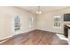 Cozy living room with a glass door to the backyard and natural light from the window at 6204 Springbeauty Dr, Charlotte, NC 28227