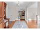 Bright entryway with hardwood floors, coat rack, and view of living room at 7650 Tuckaseegee Rd, Kannapolis, NC 28081