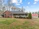 Brick ranch house with front porch and large yard at 7650 Tuckaseegee Rd, Kannapolis, NC 28081