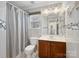 Well-lit bathroom featuring modern fixtures, tiled walls, a shower-tub combo, and decorative accents at 9903 Southampton Commons Dr, Charlotte, NC 28277