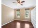 Sunny bedroom with hardwood floors, two windows, neutral walls, and a modern ceiling fan at 9903 Southampton Commons Dr, Charlotte, NC 28277