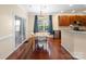 Cozy dining area featuring hardwood floors, natural light, and convenient access to the kitchen and backyard at 9903 Southampton Commons Dr, Charlotte, NC 28277