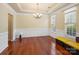 Bright dining room featuring hardwood floors, chair rail, chandelier and ample natural light from dual windows at 9903 Southampton Commons Dr, Charlotte, NC 28277