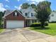 Charming two-story home with a brick facade, attached two car garage, and a well-manicured lawn at 9903 Southampton Commons Dr, Charlotte, NC 28277