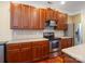 Updated kitchen featuring cherry cabinets, stainless steel appliances, and tile backsplash at 9903 Southampton Commons Dr, Charlotte, NC 28277