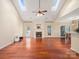 Bright living room with hardwood floors, a fireplace, vaulted ceilings, and natural light from skylights at 9903 Southampton Commons Dr, Charlotte, NC 28277