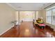 Open living and dining area with hardwood floors and lots of natural light with columns and wainscoting at 9903 Southampton Commons Dr, Charlotte, NC 28277