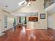 Open concept living room and dining area featuring hardwood floors, natural light, and easy kitchen access at 9903 Southampton Commons Dr, Charlotte, NC 28277