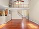 Spacious living room with hardwood floors, staircase, and a balcony overlooking the open-concept design at 9903 Southampton Commons Dr, Charlotte, NC 28277