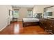 Comfortable main bedroom with hardwood floors, dual windows, a TV, and a dark wood dresser at 9903 Southampton Commons Dr, Charlotte, NC 28277