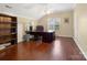 Spacious home office features a large desk, hardwood floors, and abundant natural light at 9903 Southampton Commons Dr, Charlotte, NC 28277