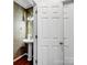 Charming powder room with pedestal sink, elegant wallpaper, and hardwood floors at 9903 Southampton Commons Dr, Charlotte, NC 28277