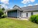 Backyard featuring a screen porch, lush green lawn, and vibrant flowers enhancing the outdoor space at 9903 Southampton Commons Dr, Charlotte, NC 28277