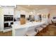 Modern kitchen with white cabinets, quartz countertops, and an island at 1014 Merganser Way, Indian Trail, NC 28079