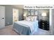 Bedroom with light blue bedding and ensuite bathroom at 2023 Canvasback Way, Indian Trail, NC 28079