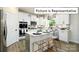 White kitchen with an island and chevron backsplash at 1023 Canvasback Way, Indian Trail, NC 28079