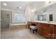 Spacious bathroom featuring dual vanities, a soaking tub and shower, and ceramic tile at 1102 High Brook Dr, Waxhaw, NC 28173