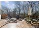 Relaxing backyard deck with outdoor seating, grill, lounge chairs, and peaceful wooded views at 1102 High Brook Dr, Waxhaw, NC 28173