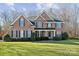 Brick two-story house with a large front yard and mature trees at 1102 High Brook Dr, Waxhaw, NC 28173