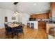 Eat-in kitchen featuring a table with chairs, hardwood floors, granite countertops, and pendant lighting at 1102 High Brook Dr, Waxhaw, NC 28173