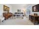 Elegant living room with piano, decorative dresser, neutral color scheme, and bright natural light at 1102 High Brook Dr, Waxhaw, NC 28173