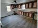 A galley kitchen with wood cabinets and new vinyl flooring at 111 Dye St, Chester, SC 29706