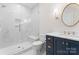 Modern bathroom features marble walk-in shower with a bench and navy blue vanity at 124 Saylors Watch Ln, Mooresville, NC 28117