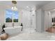 Bright bathroom featuring a modern tub, beautiful tile work and walk-in shower at 124 Saylors Watch Ln, Mooresville, NC 28117