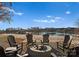 Outdoor fire pit with Adirondack chairs overlooking a serene lake and sandy beach, perfect for relaxing evenings at 124 Saylors Watch Ln, Mooresville, NC 28117