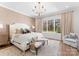 Bright main bedroom with large window, soft neutral tones and decorative chandelier at 124 Saylors Watch Ln, Mooresville, NC 28117