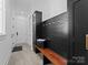 Mudroom with bench, black accent wall and cabinets for storage at 124 Saylors Watch Ln, Mooresville, NC 28117