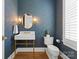 Stylish powder room with gold fixtures and blue patterned wallpaper at 124 Saylors Watch Ln, Mooresville, NC 28117