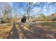 Private backyard with mature trees and a view of the house at 1357 Meadowdale Rd, Rock Hill, SC 29732