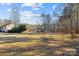 Spacious backyard with a view of the surrounding trees and partial view of the house at 1357 Meadowdale Rd, Rock Hill, SC 29732