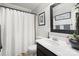 Clean bathroom with dark vanity, white shower curtain, and framed art at 1511 Longbrook Dr, Charlotte, NC 28270