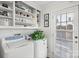 Laundry room with washer, dryer, and extra shelving at 1511 Longbrook Dr, Charlotte, NC 28270