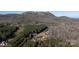 Aerial view of property showing home, outbuildings, and mountain views at 247 Camp Rotary Rd, Gastonia, NC 28052