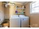 Laundry room with washer, dryer, and shelving at 247 Camp Rotary Rd, Gastonia, NC 28052