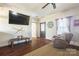 Living room with hardwood floors and a large TV at 247 Camp Rotary Rd, Gastonia, NC 28052