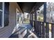 Covered porch with wooden railings and lighting at 247 Camp Rotary Rd, Gastonia, NC 28052